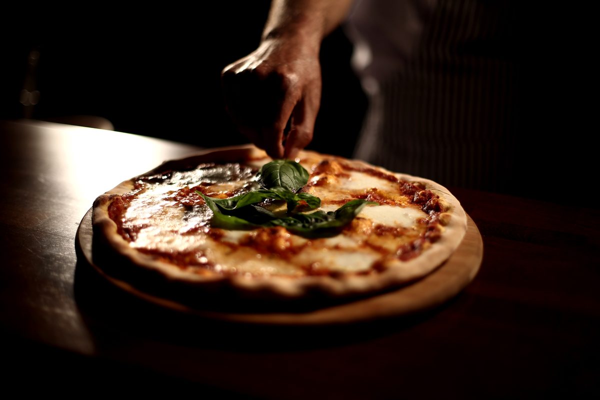 Pizza coming out of the oven at Tonino's Pizzeria